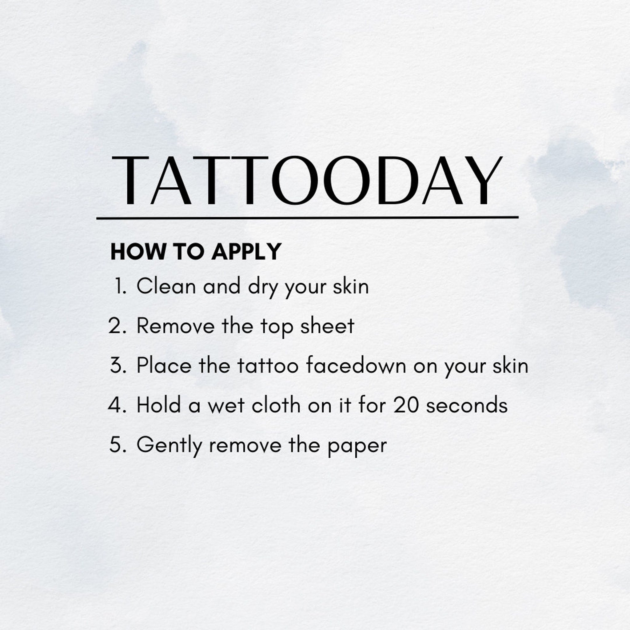 Close-up of a temporary tattoo UFO set being applied to clean, moisturized skin with fingertips