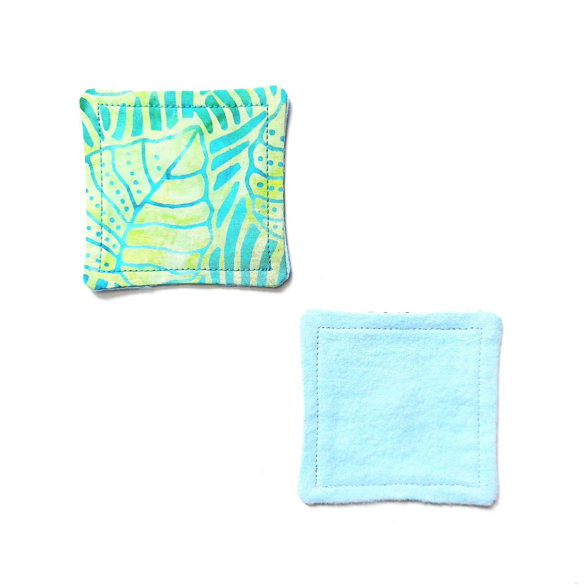 Reusable cotton pads with patterned fabric, blue fabric, and stitched edges