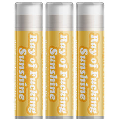 Lip balm tubes in yellow with white text, clear cap, Delight Naturals "Ray of Sunshine