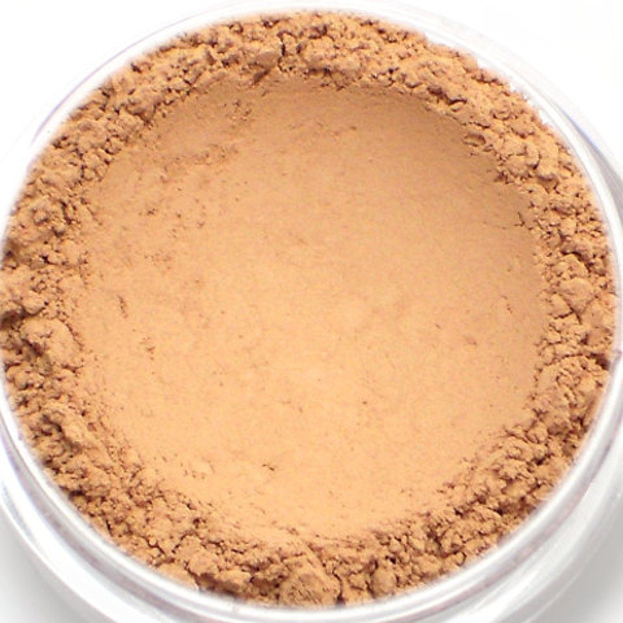 Powder makeup, light brown powder with rough texture in clear container