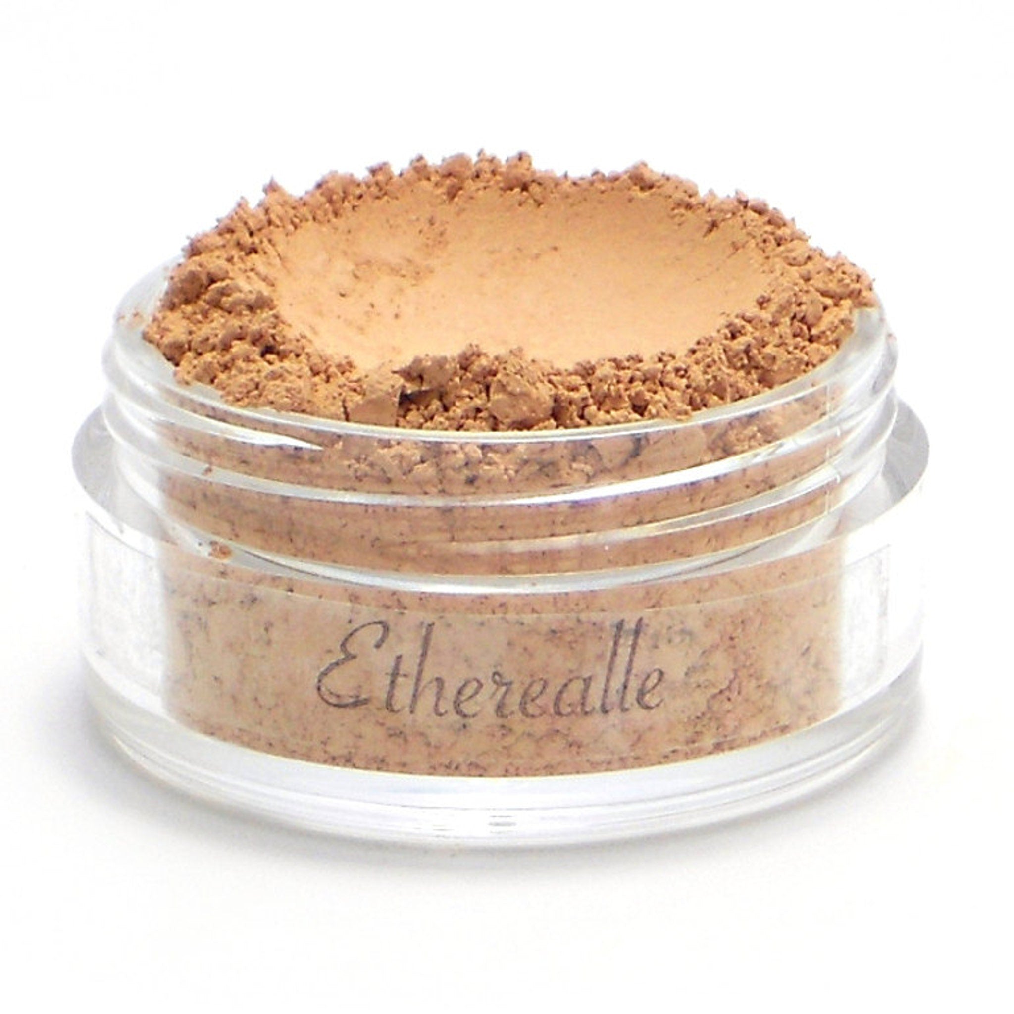 Powder makeup in a clear jar with light brown color and Etherealle brand name visible