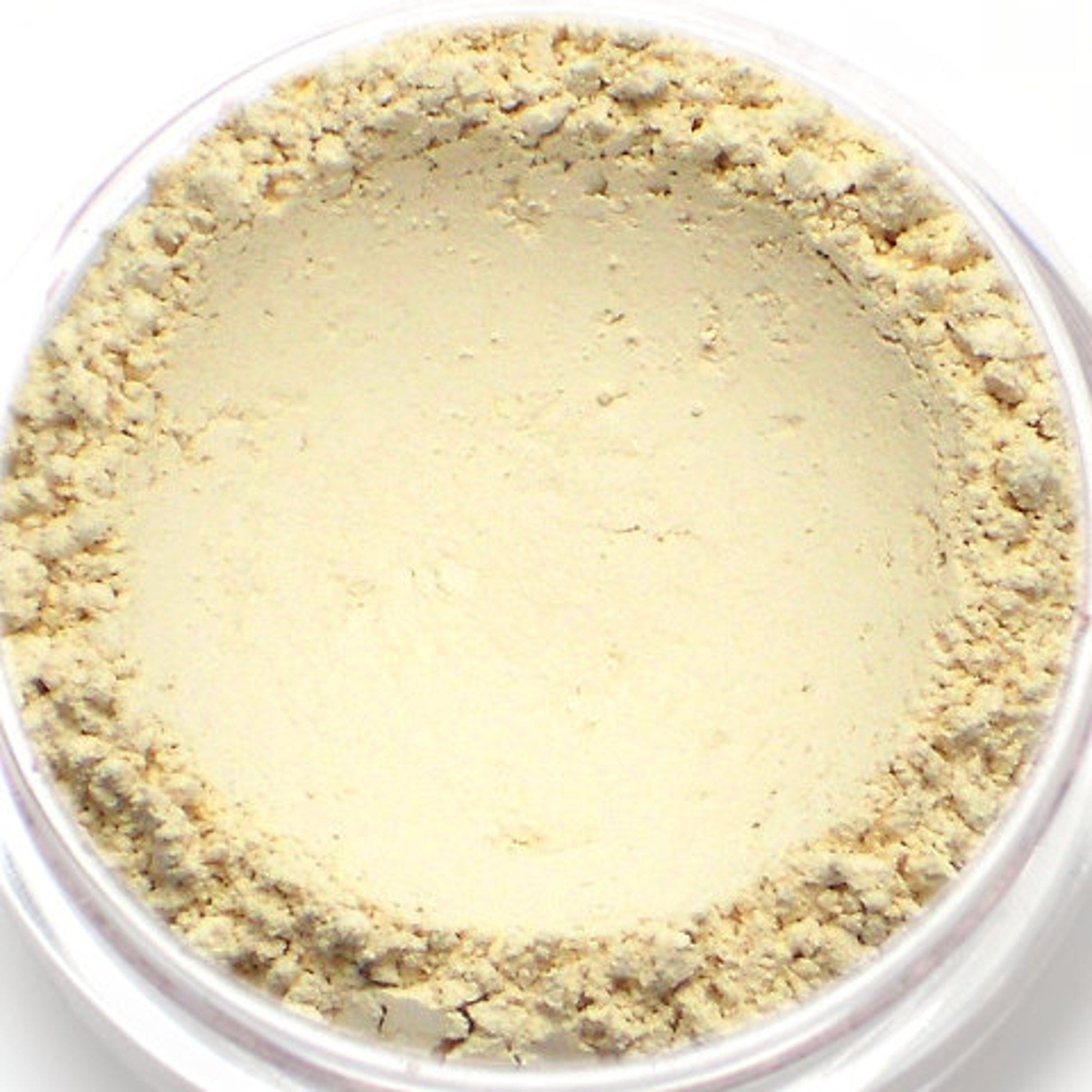 Close-up of creamy off-white matte eyeshadow pan with smooth mineral texture and subtle sheen