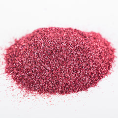 Close-up of holographic pink glitter eyeshadow with ultrafine shimmer particles catching the light