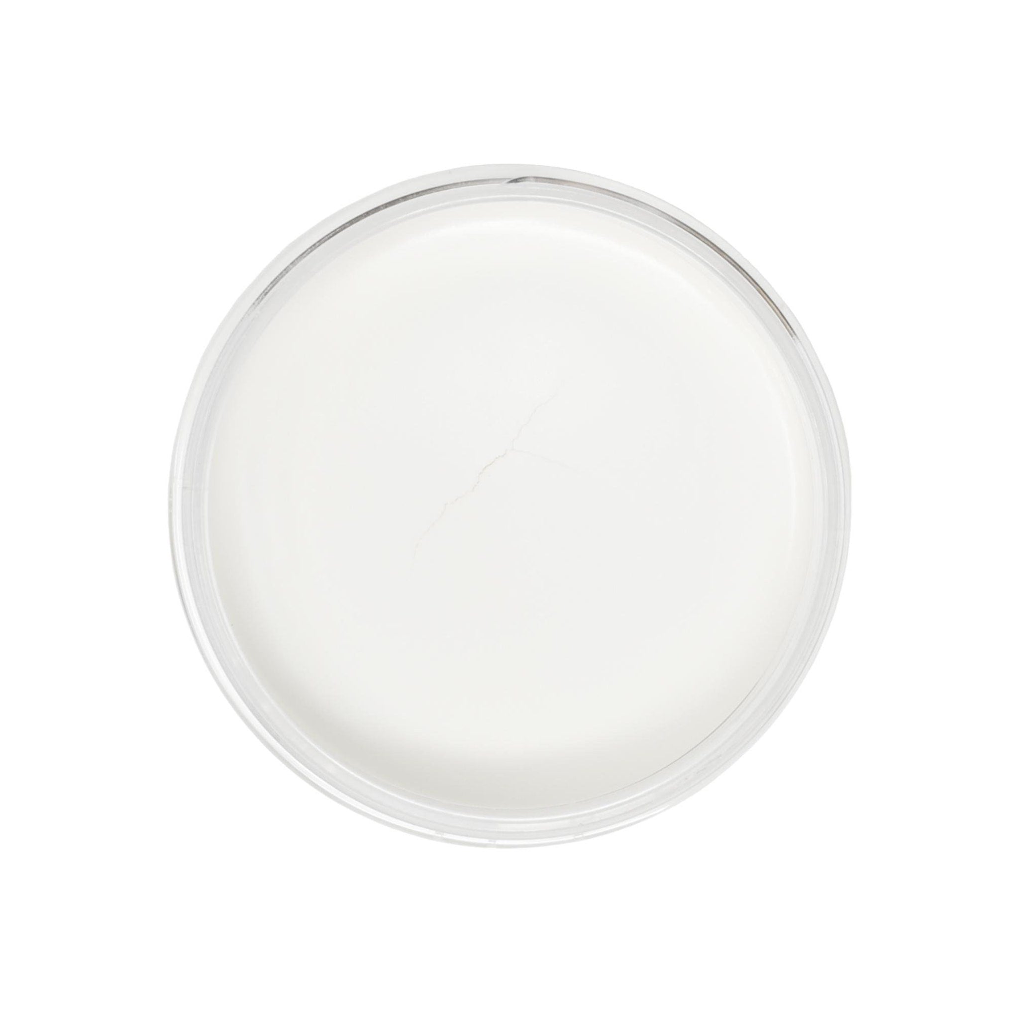 White cream in clear glass bowl with crack, top view
