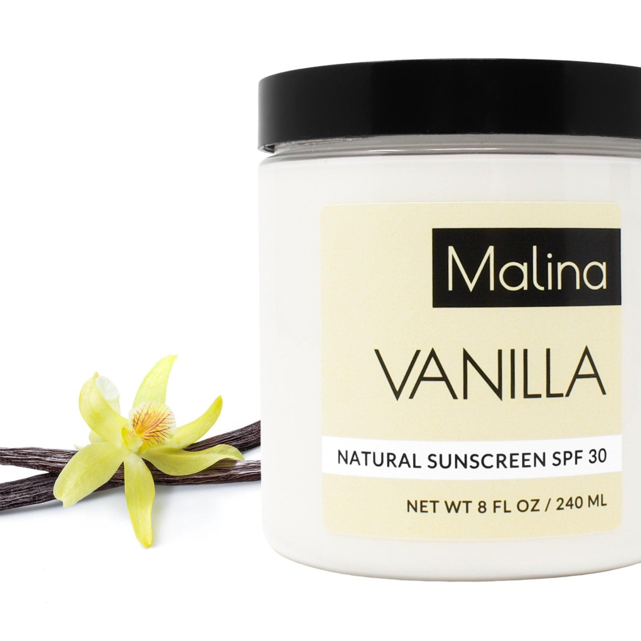 Sunscreen jar with black lid, white label, and vanilla flower and pods on white background