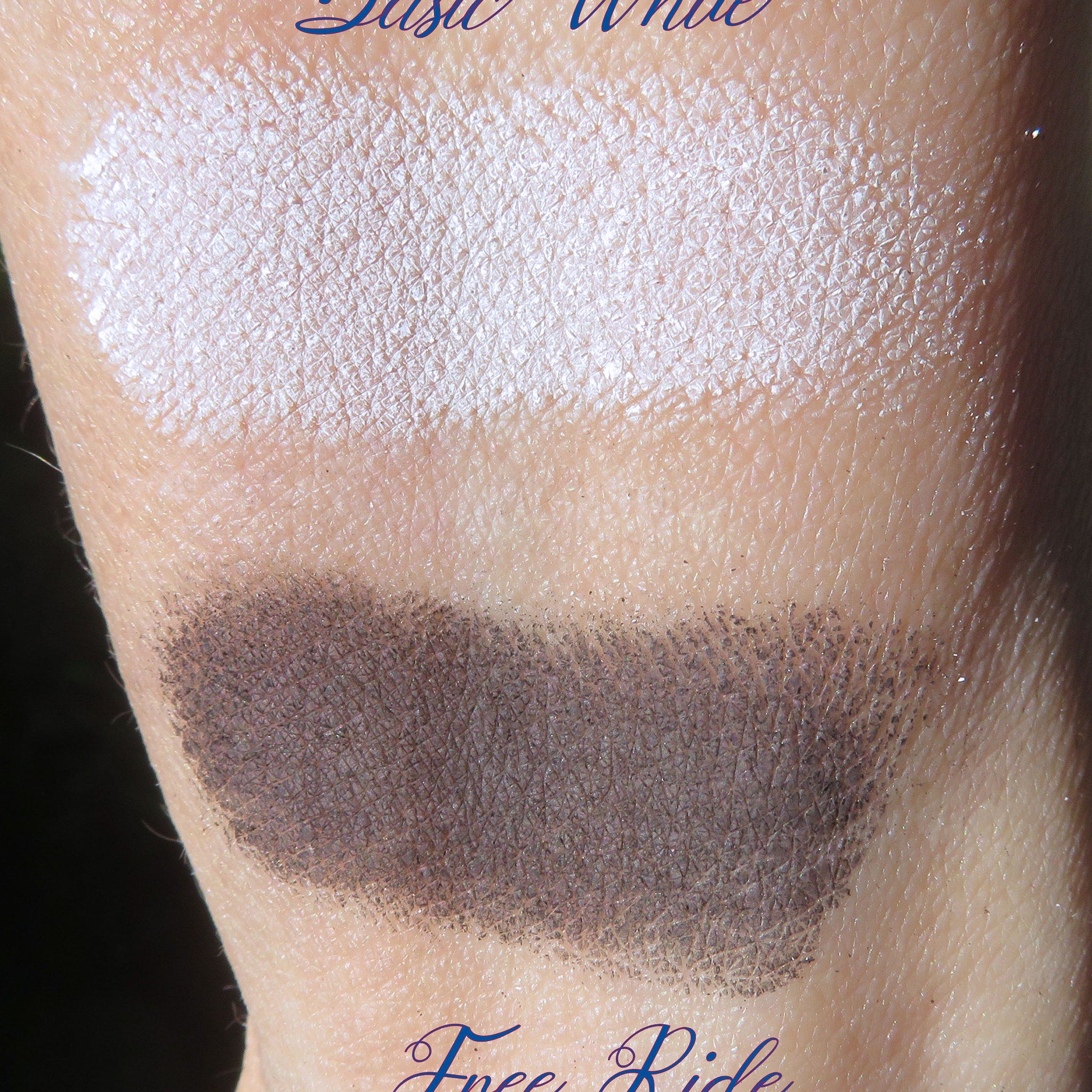 Eyeshadow swatches, white and dark brown, textured, applied on skin, close up view