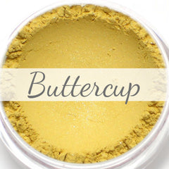 Shimmery pale yellow vegan mineral eyeshadow in compact with gold-toned case, shown open.