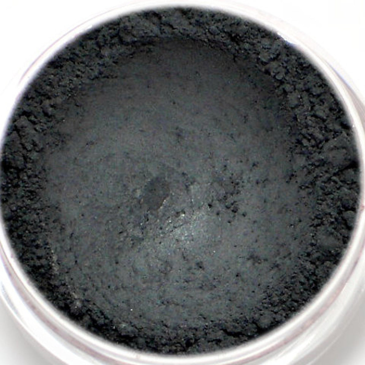 Matte black vegan eyeshadow in compact with Nero label, showcasing opaque mineral pigment texture.