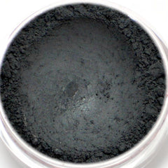 Matte black vegan eyeshadow in compact with Nero label, showcasing opaque mineral pigment texture.