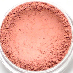 Close-up of matte light pink vegan mineral eyeshadow in compact with sleek black case and visible product pan.