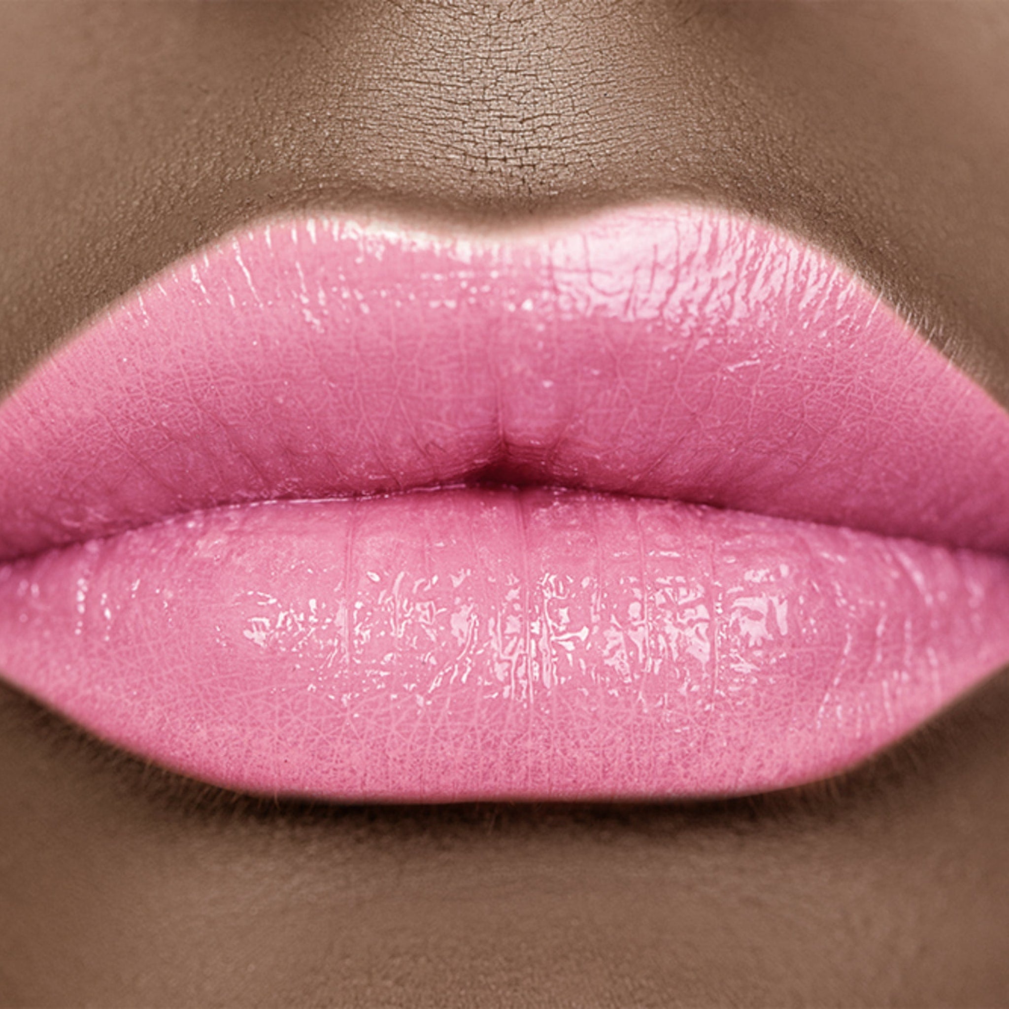 Lip gloss, pink glossy lips with skin texture visible, close up view of mouth