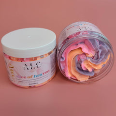 Close-up of whipped passionfruit-scented body butter in a gold jar, showcasing its creamy texture and organic ingredients