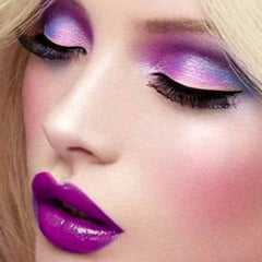 Side view of purple mineral eyeshadow cake in compact with shimmering pigment texture