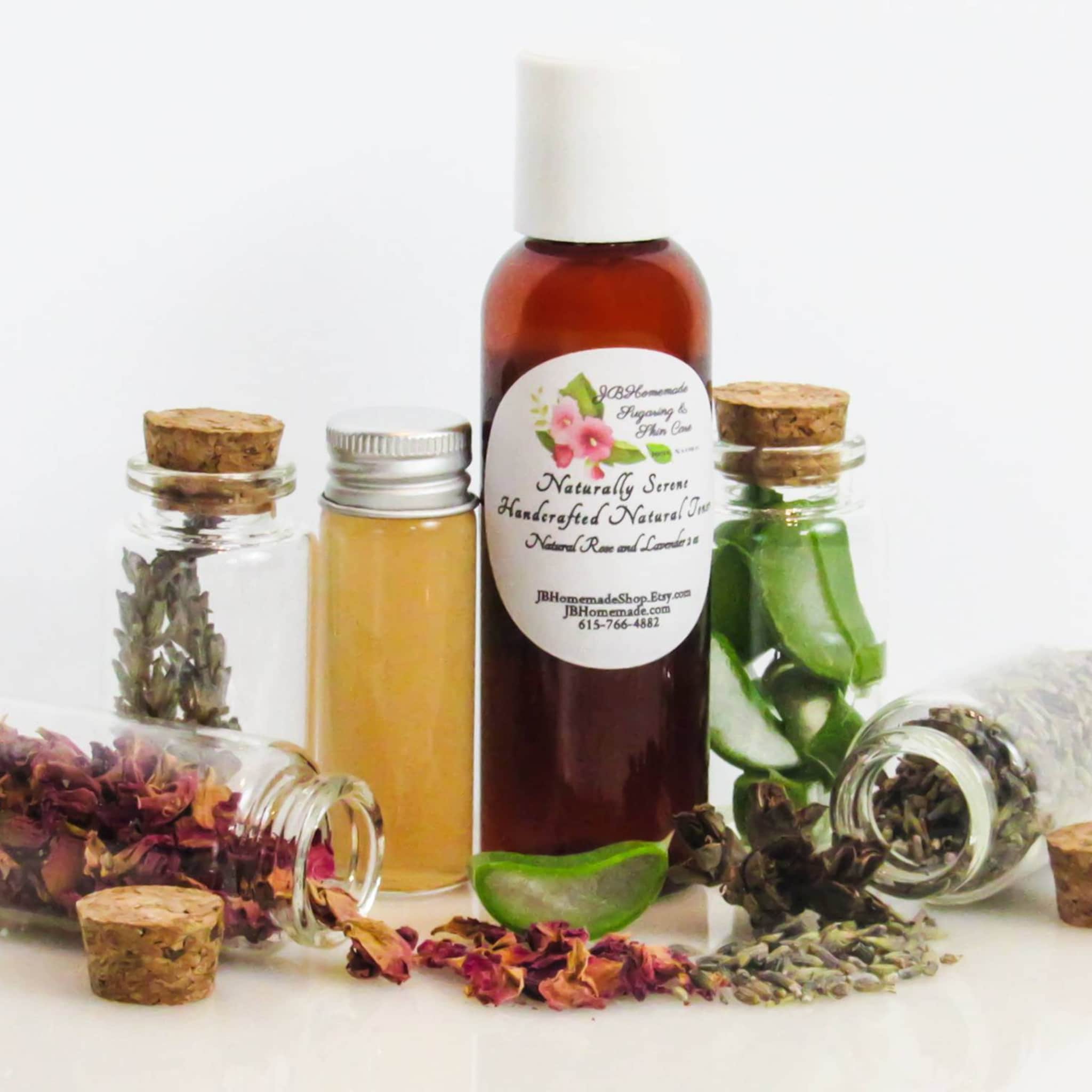 Bottles with corks, glass, and brown liquid, with lavender, rose petals, and aloe vera, JBHomemade label visible