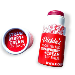 Lip balm tubes in red and white with Pickle's branding and strawberry cream flavor text visible