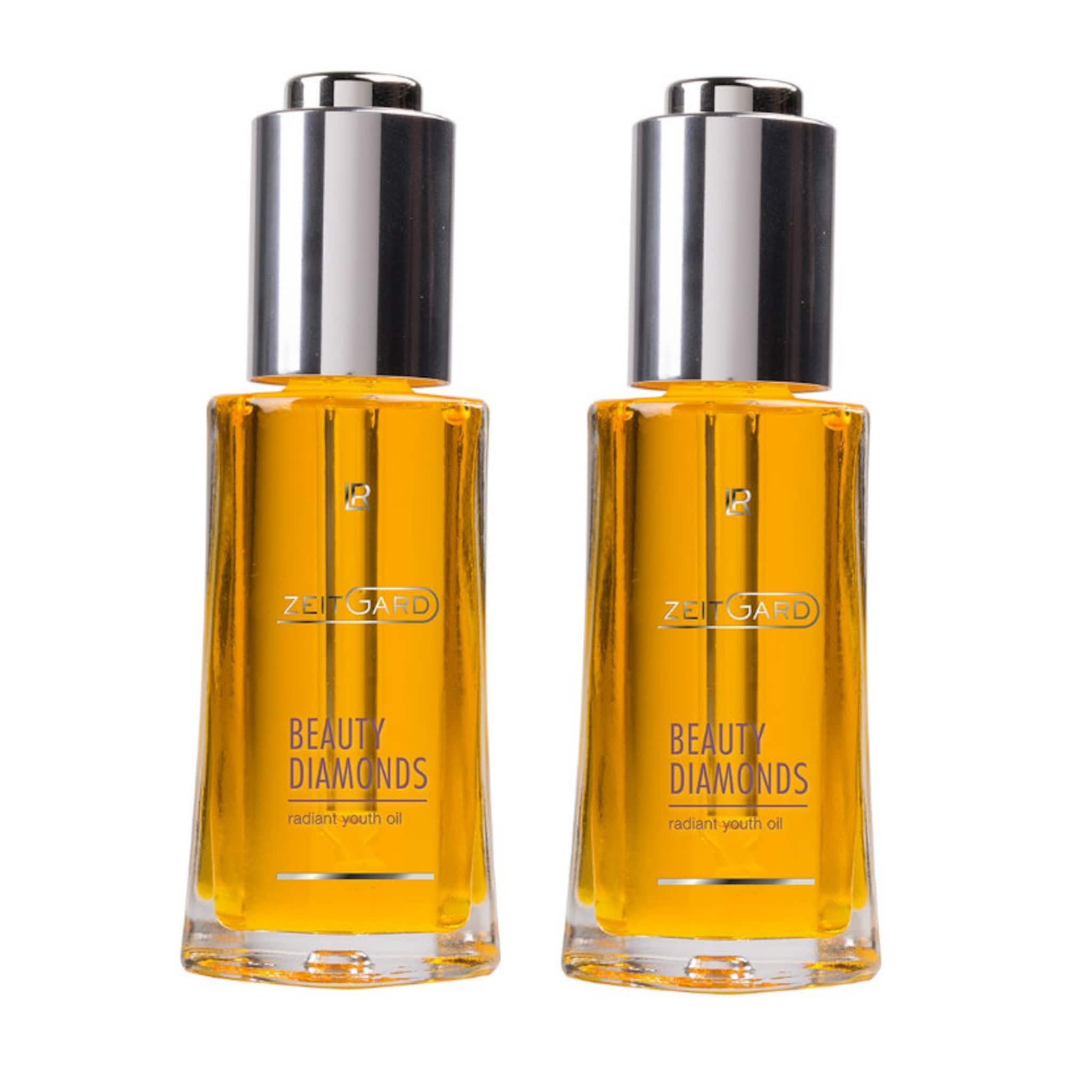 Beauty oil bottles with silver cap, yellow liquid, and "BEAUTY DIAMONDS" text