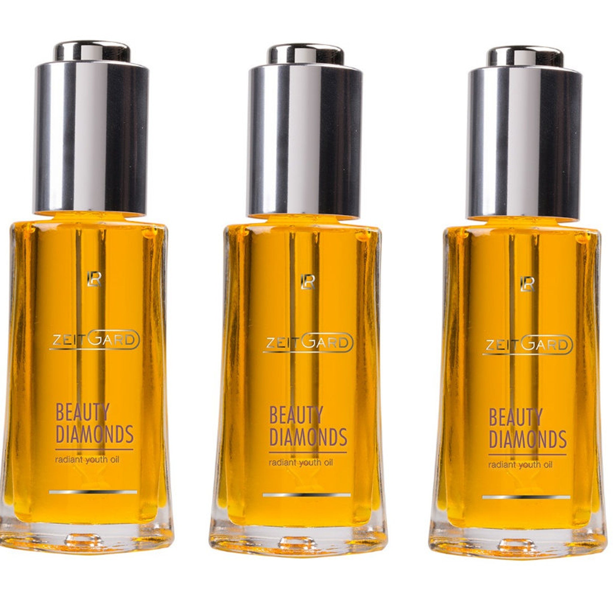 Beauty oil bottles with silver cap, gold liquid, and Zeitgard branding