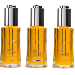 Beauty oil bottles with silver cap, gold liquid, and Zeitgard branding