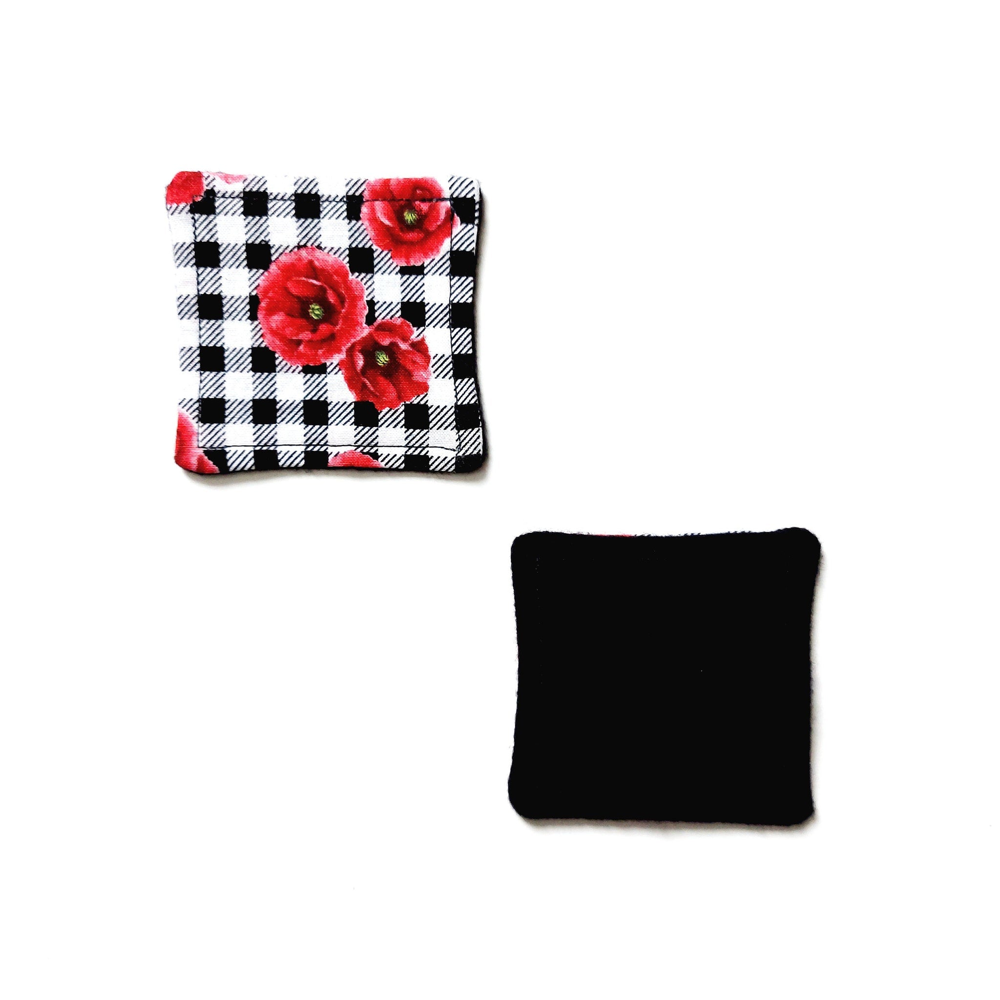 Square fabric pads with floral print, black and white gingham, and solid black color