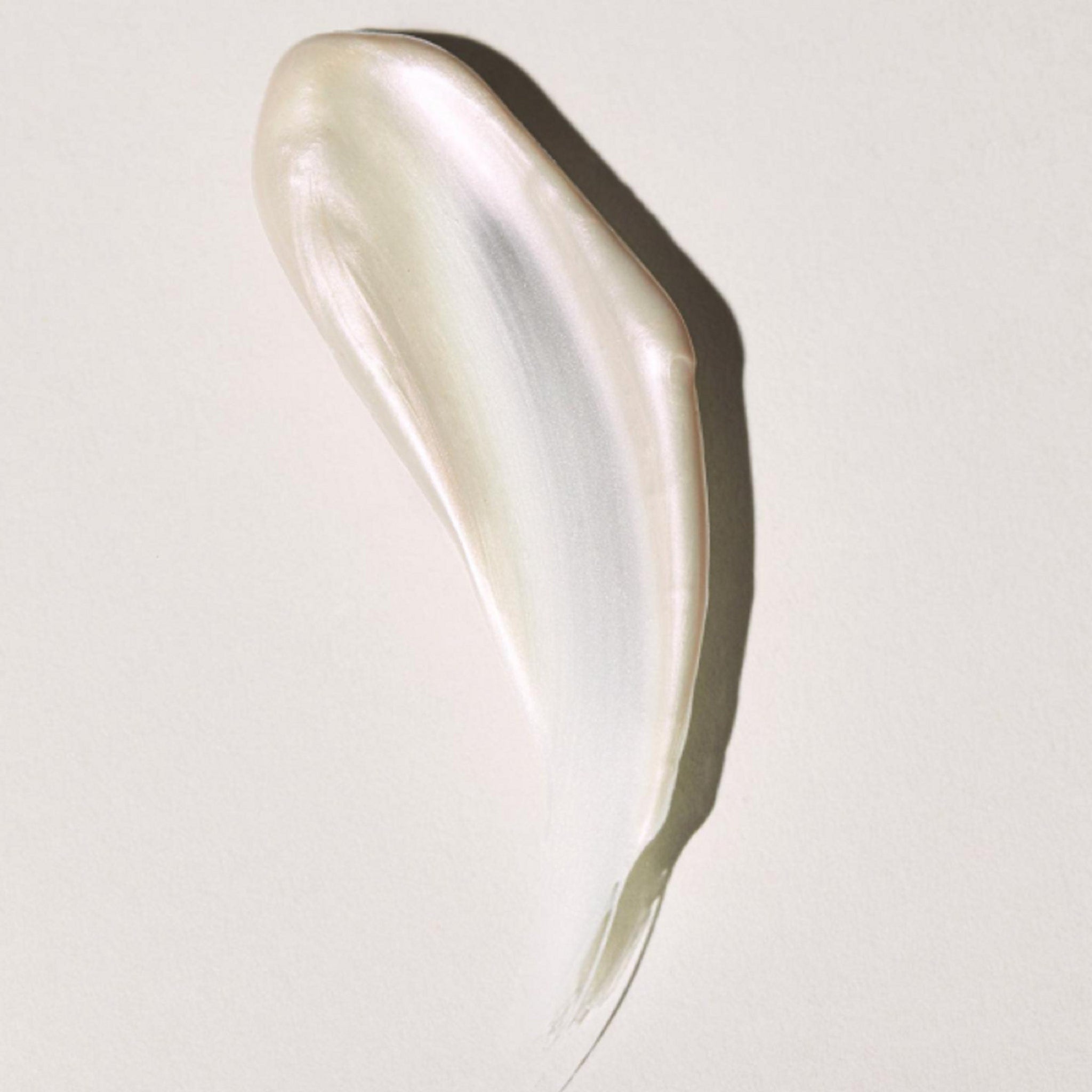 Cream swatch with pearlescent finish, light color, and smooth texture on white background