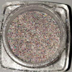 Close-up of shimmering loose glitter eye shadow with sparkling particles catching the light