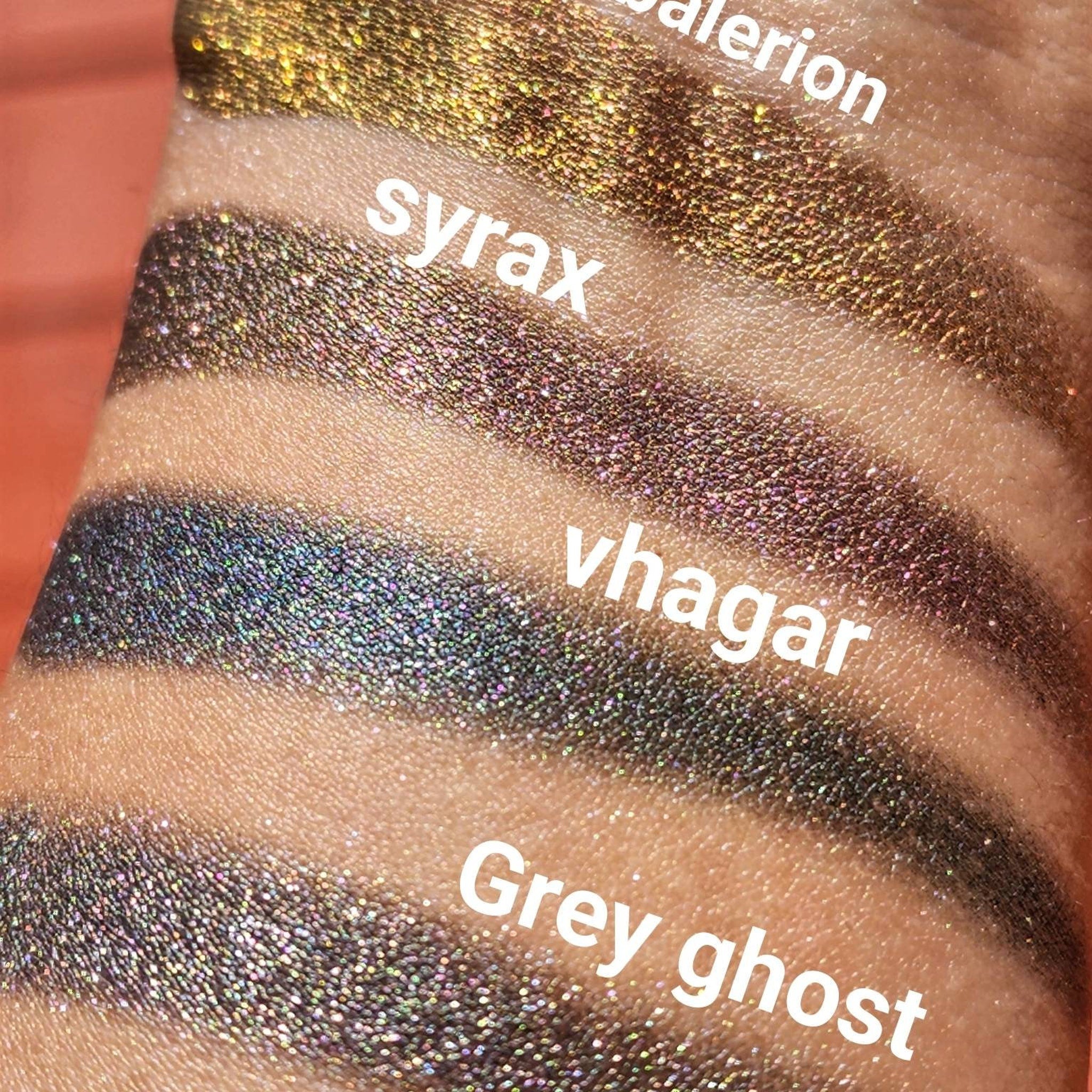 Eyeshadow swatches with metallic gold, silver, and grey shimmer on skin, with text labels for each color