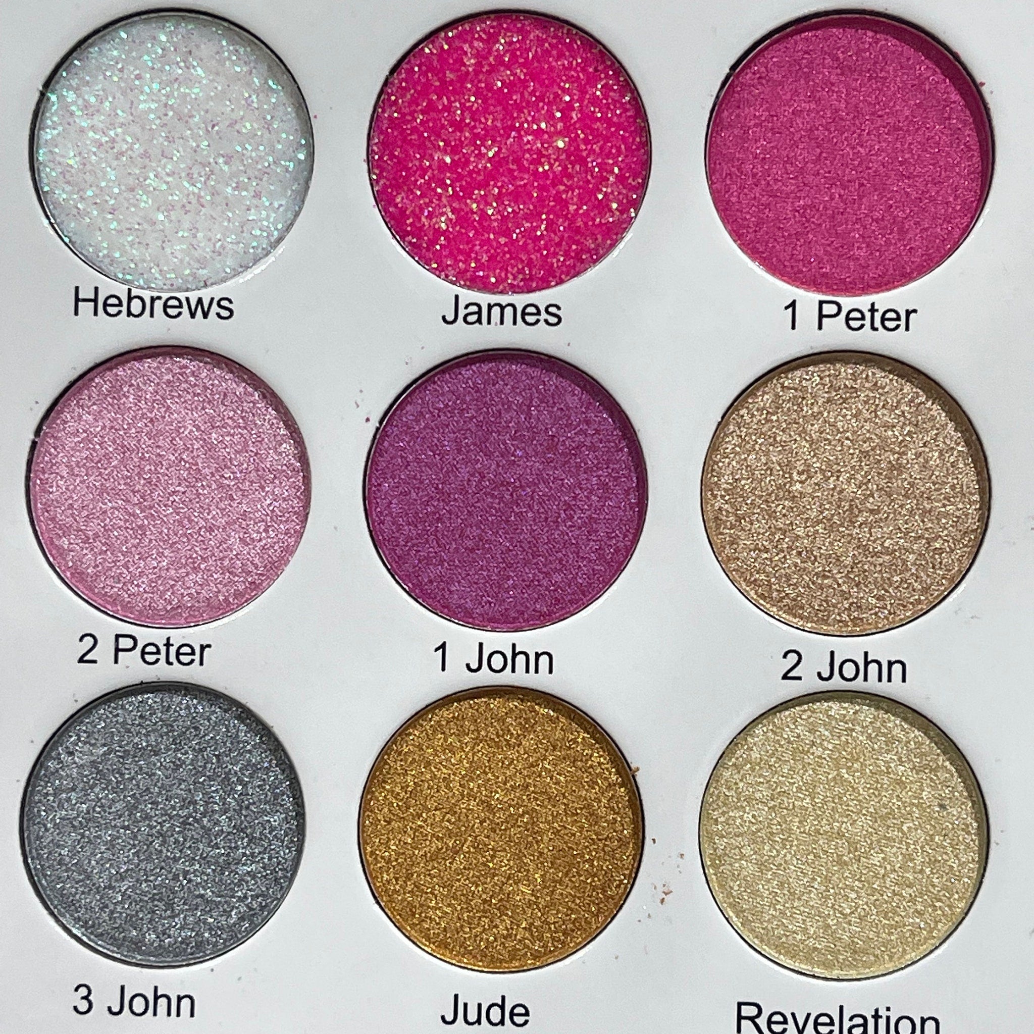 Eyeshadow palette with glitter, pink, purple, gold, and silver shades for eye makeup