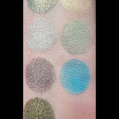 Close-up of multichrome eyeshadow palette showing shifting iridescent hues from bronze to green