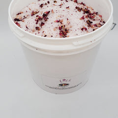 Rose bath salts with white crystals, red petals, and Ameelah Essentials label in bucket