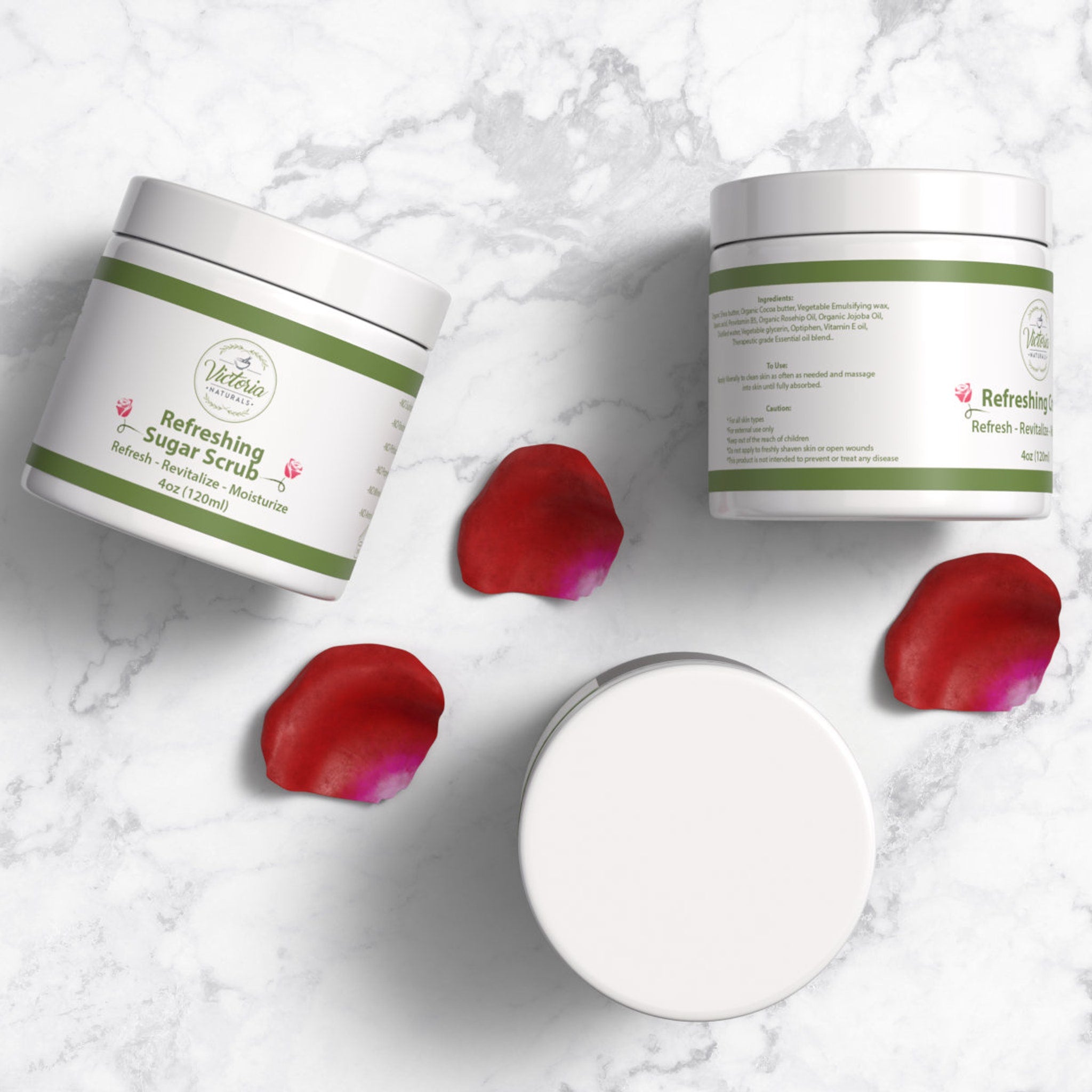 Sugar scrub jars, white and green label, with red rose petals, Victoria Naturals branding visible