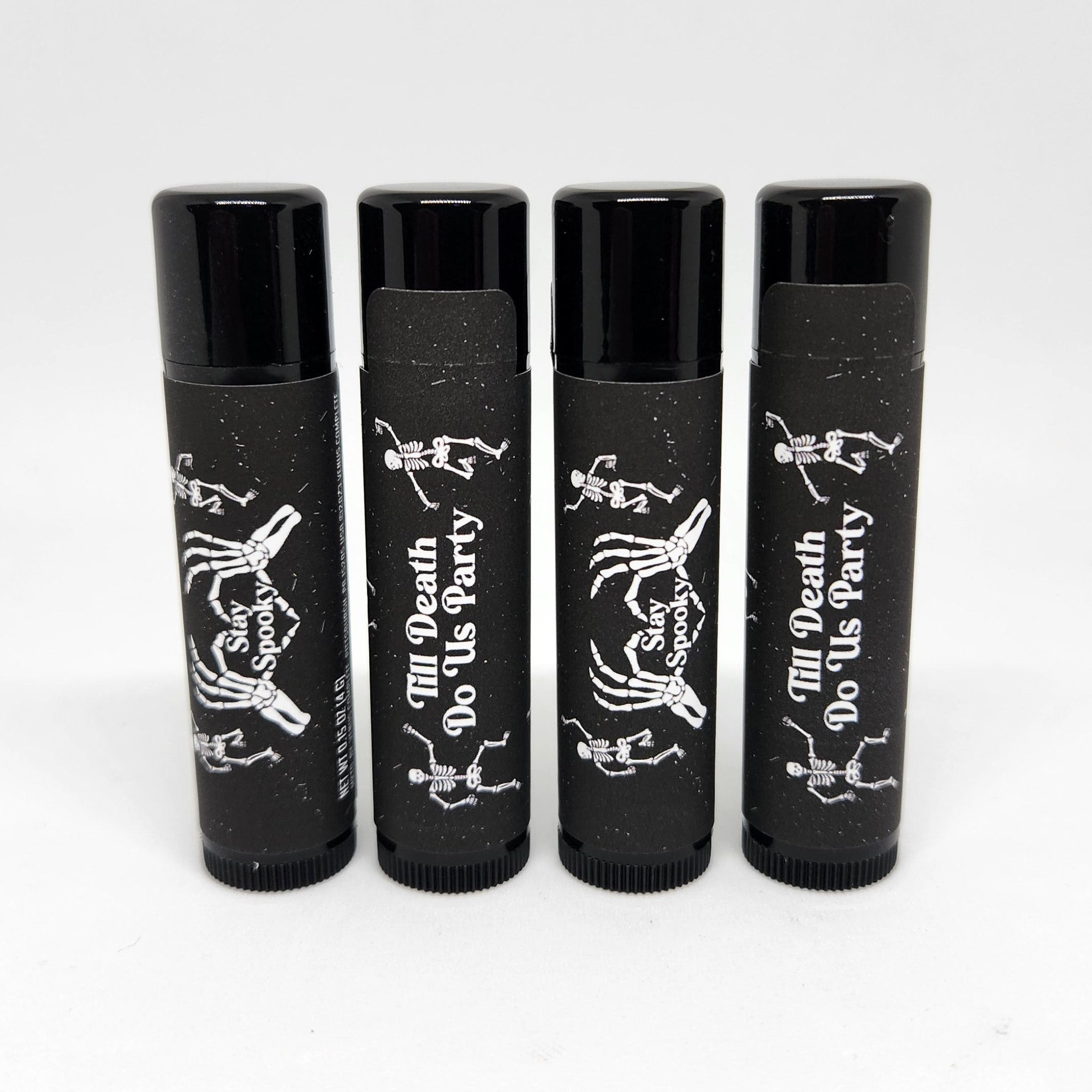 Lip balm tubes with black and white skeleton design, "Stay Spooky" and "Till Death Do Us Party" text