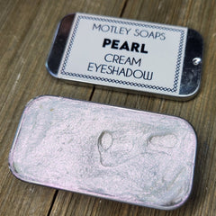 Pearlescent cream eyeshadow in a sleek silver tube with iridescent color shift effect
