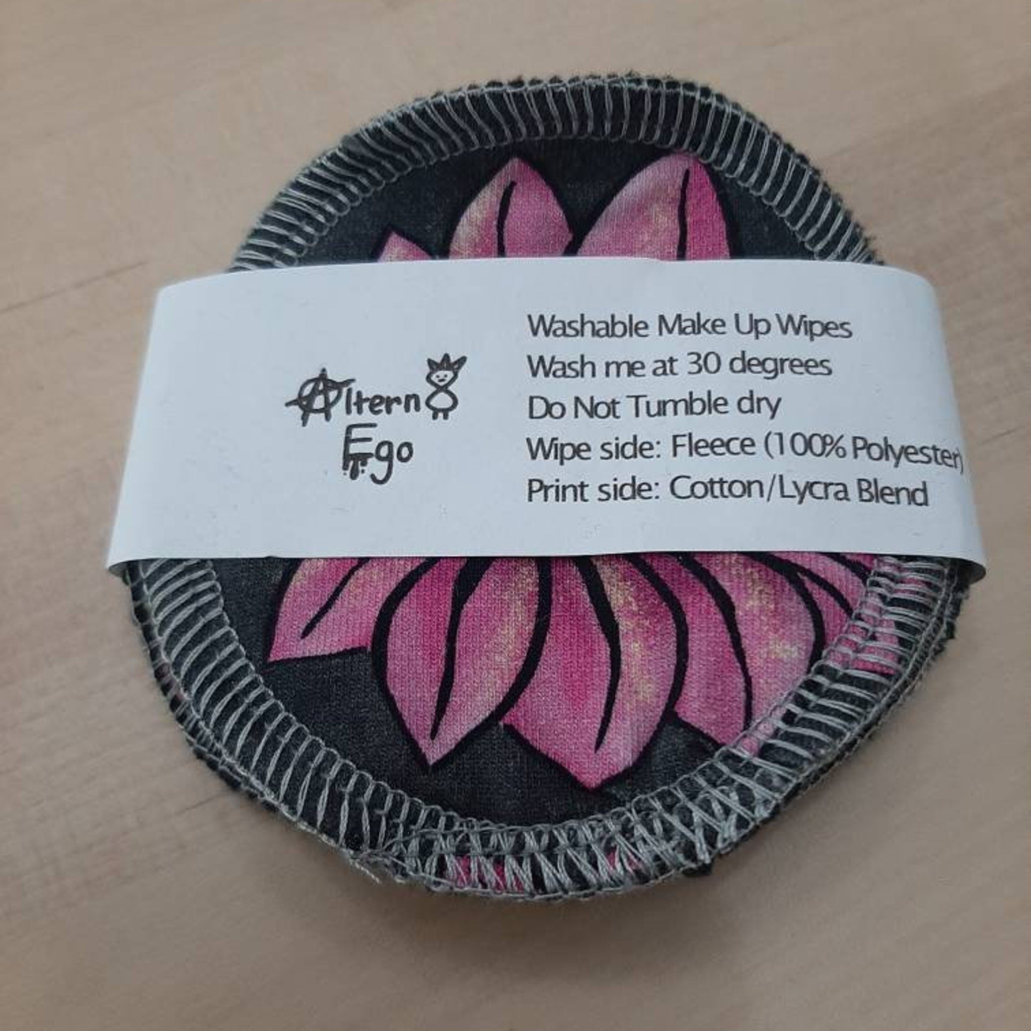 Washable makeup wipes with pink floral pattern, gray stitched edge, and Altern Ego brand name visible