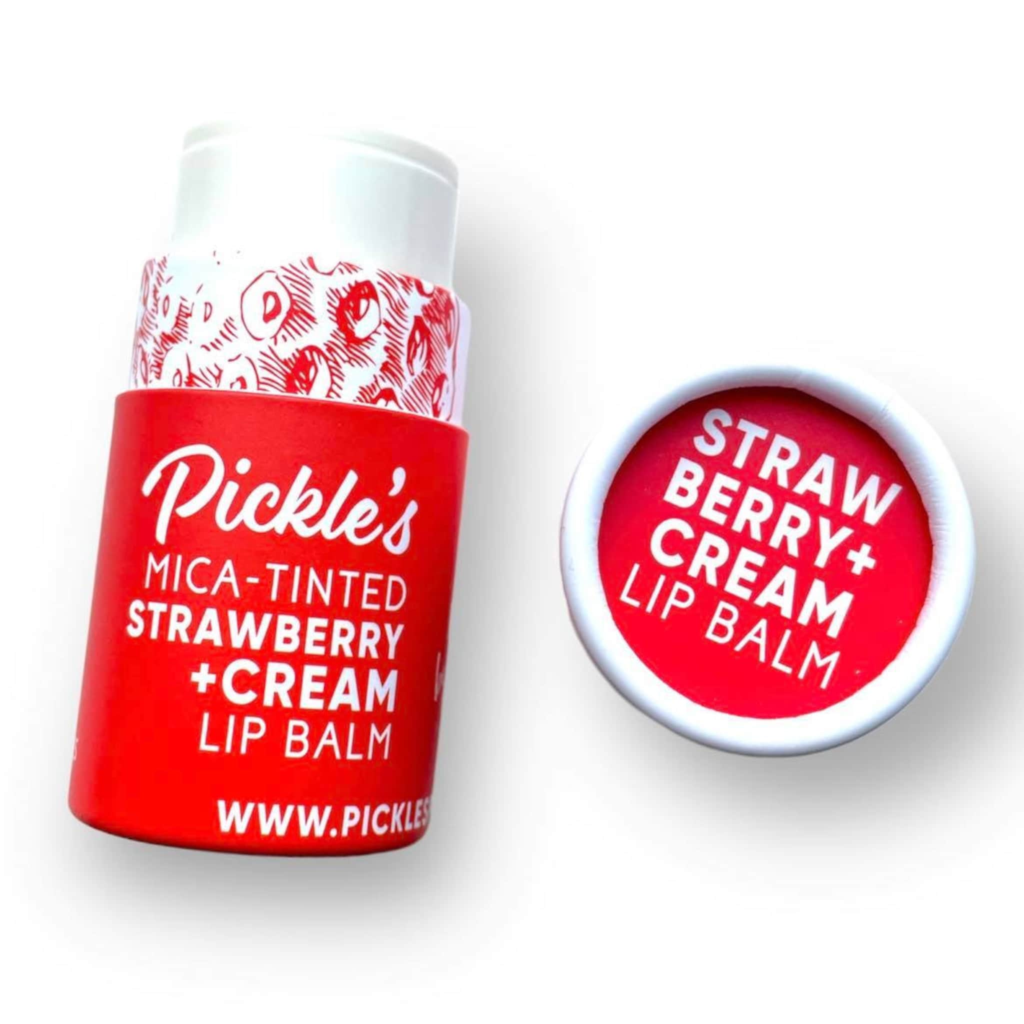 Lip balm tube with red and white packaging, Pickle's brand name, and strawberry cream text