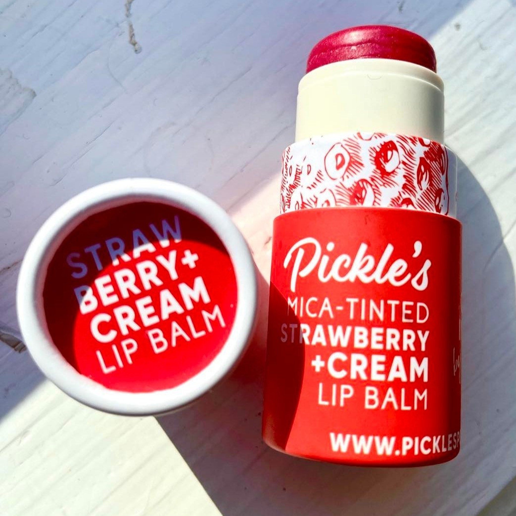 Lip balm, red and white tube, "Pickle's" brand, strawberry cream flavor, open and closed containers