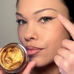 Side view of gold glitter gel pot showing creamy texture and vegan label details