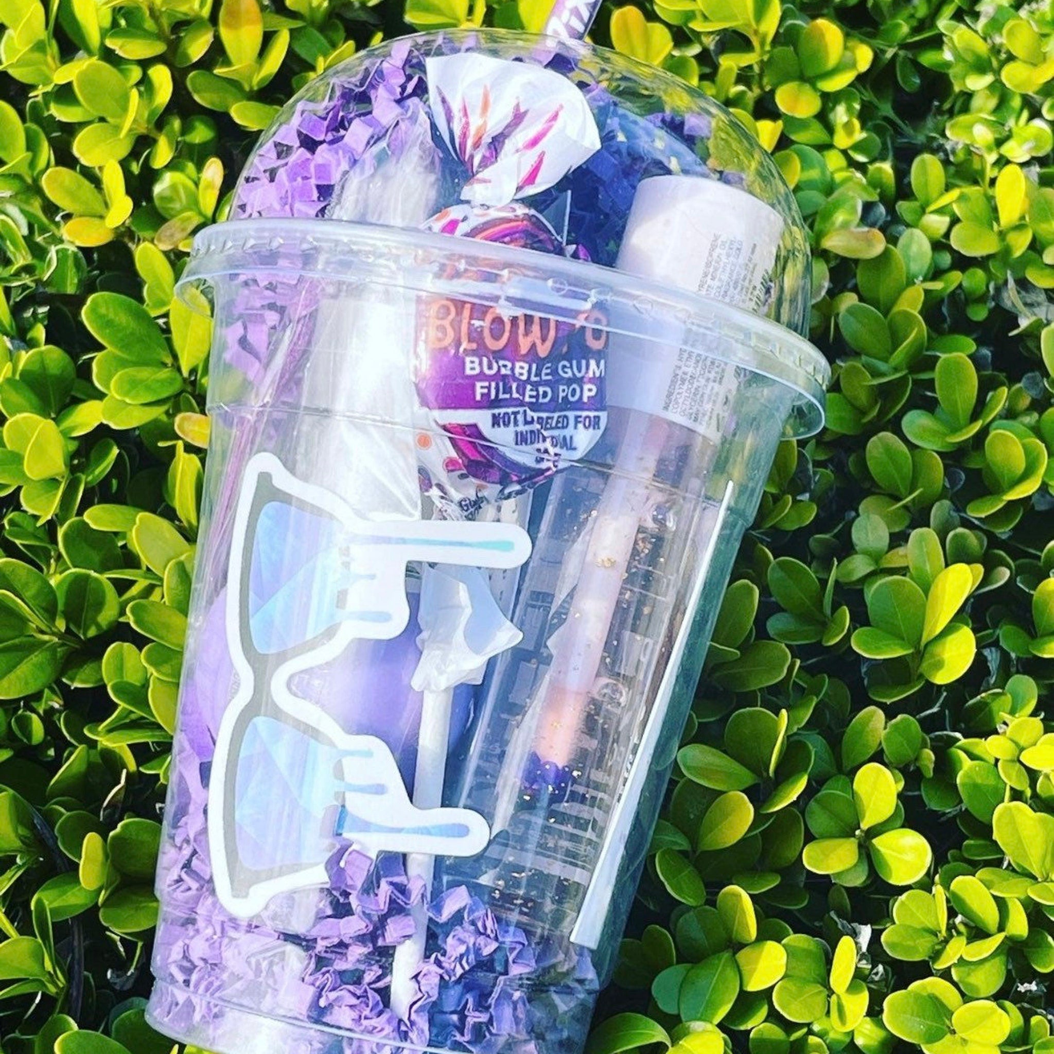 Bubble gum filled pop in clear plastic cup with purple confetti and "BLOW" text