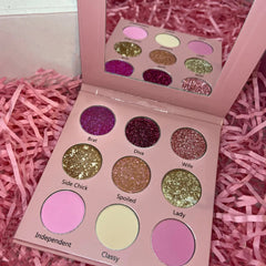 Close-up of Bratty Doll Eye Shadow Palette showing 12 vibrant matte and shimmer shades in a sleek black compact