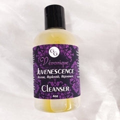 Cleanser bottle with black cap, clear liquid, and Véronique label with purple pattern
