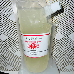 Peppermint lip gloss in clear plastic pouch with white label and red accents, Bossy Girlz Cosmetics
