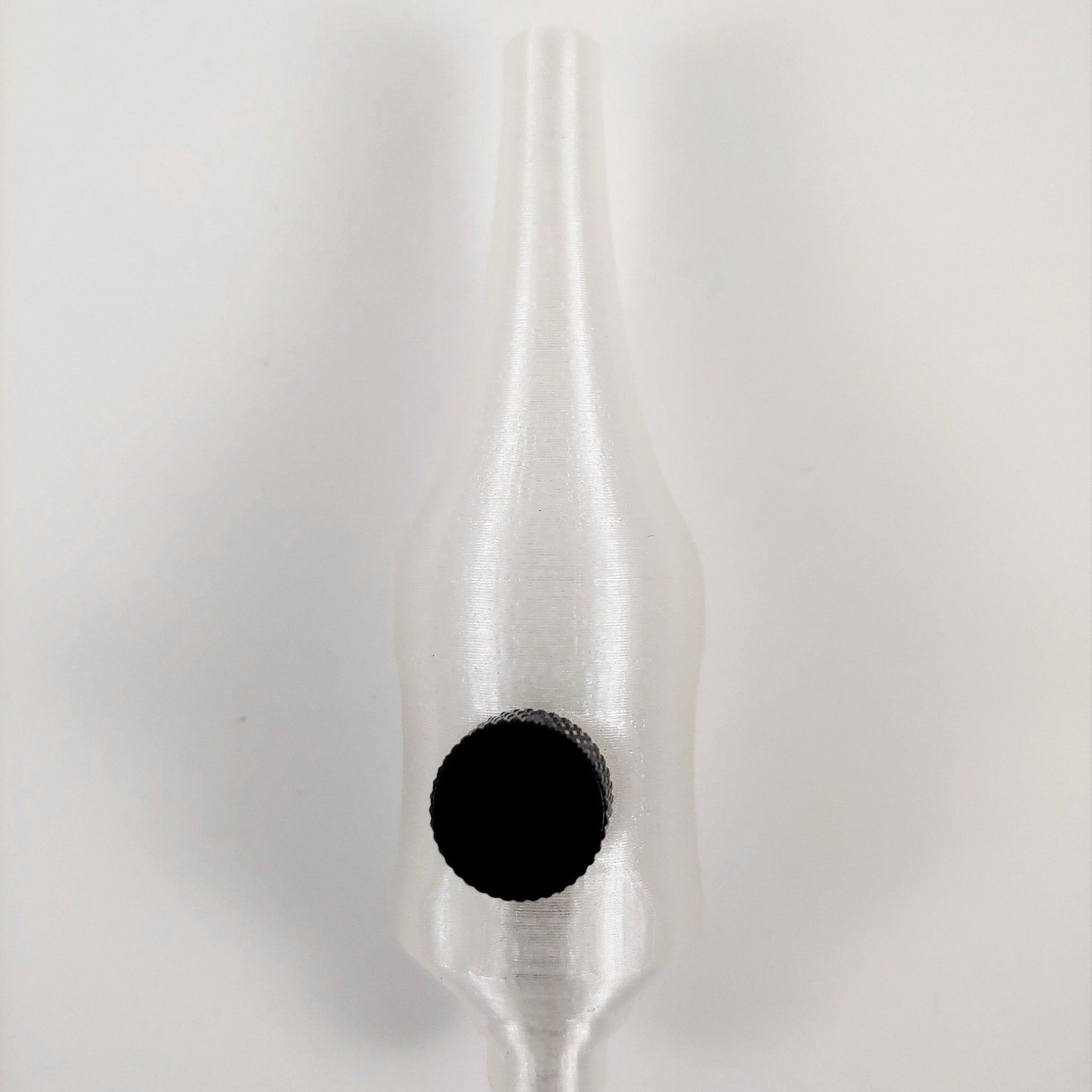 Close-up of 25mm stainless steel handpoke skincare tool with rounded tip for gentle facial treatments