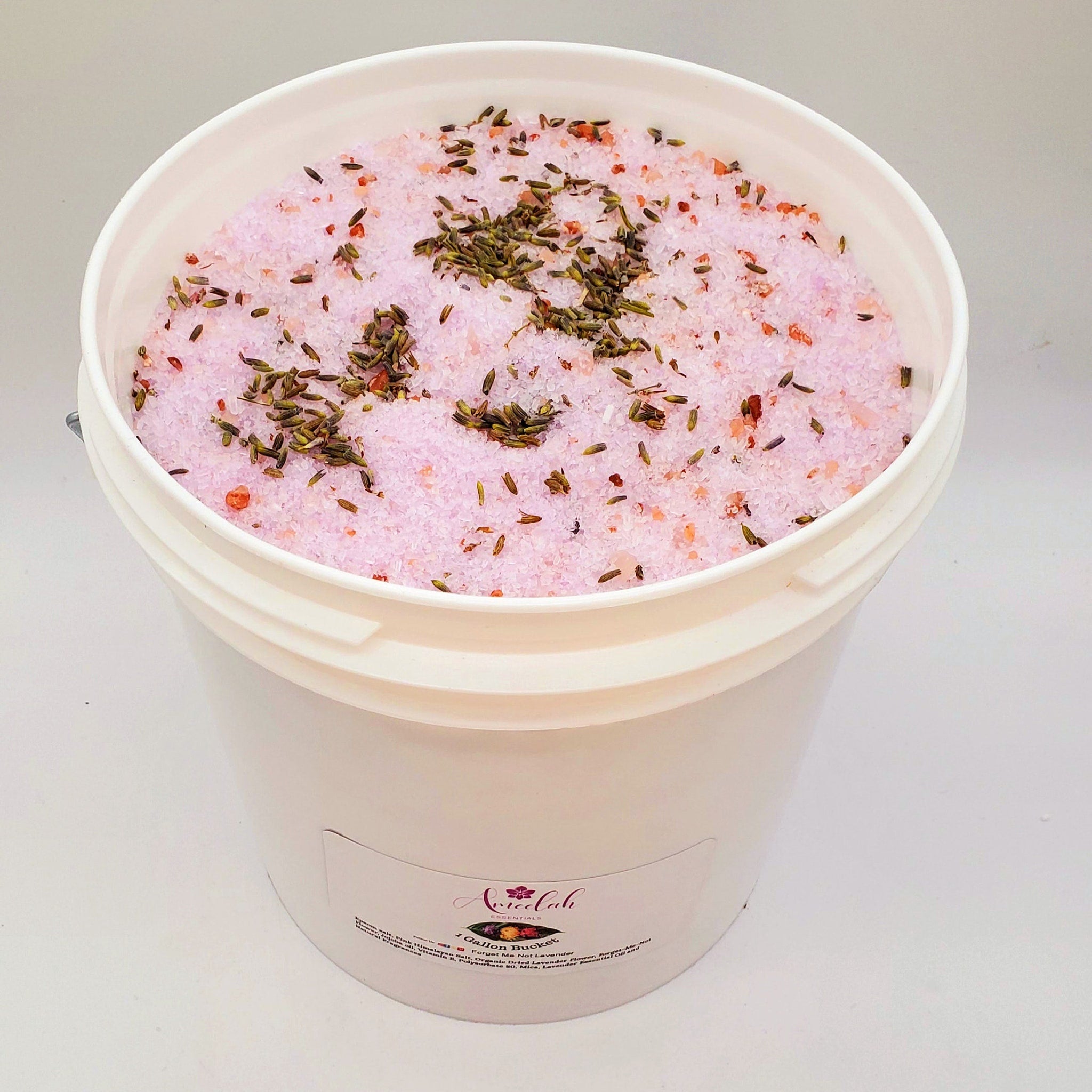 Lavender bath salts with pink granules, dried lavender, and white bucket, Ameelah Essentials