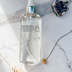Toner spray bottle, clear liquid, silver cap, Botanical Girlfriend label, on marble surface