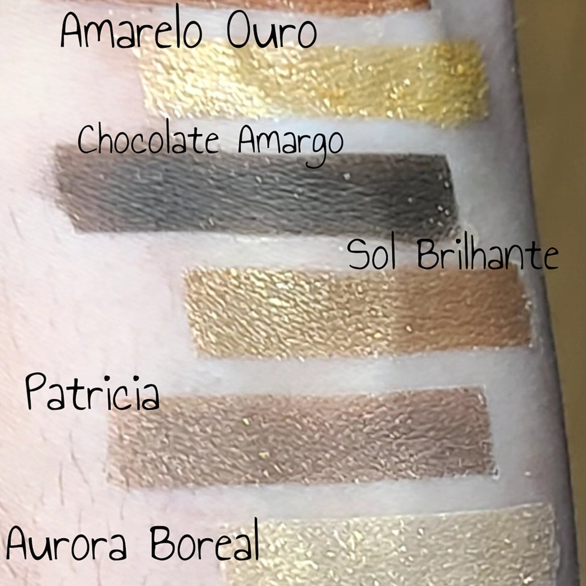 Side view of Patty Costa 12-color eyeshadow palette showing rectangular pans with matte and shimmer shades in warm neutrals