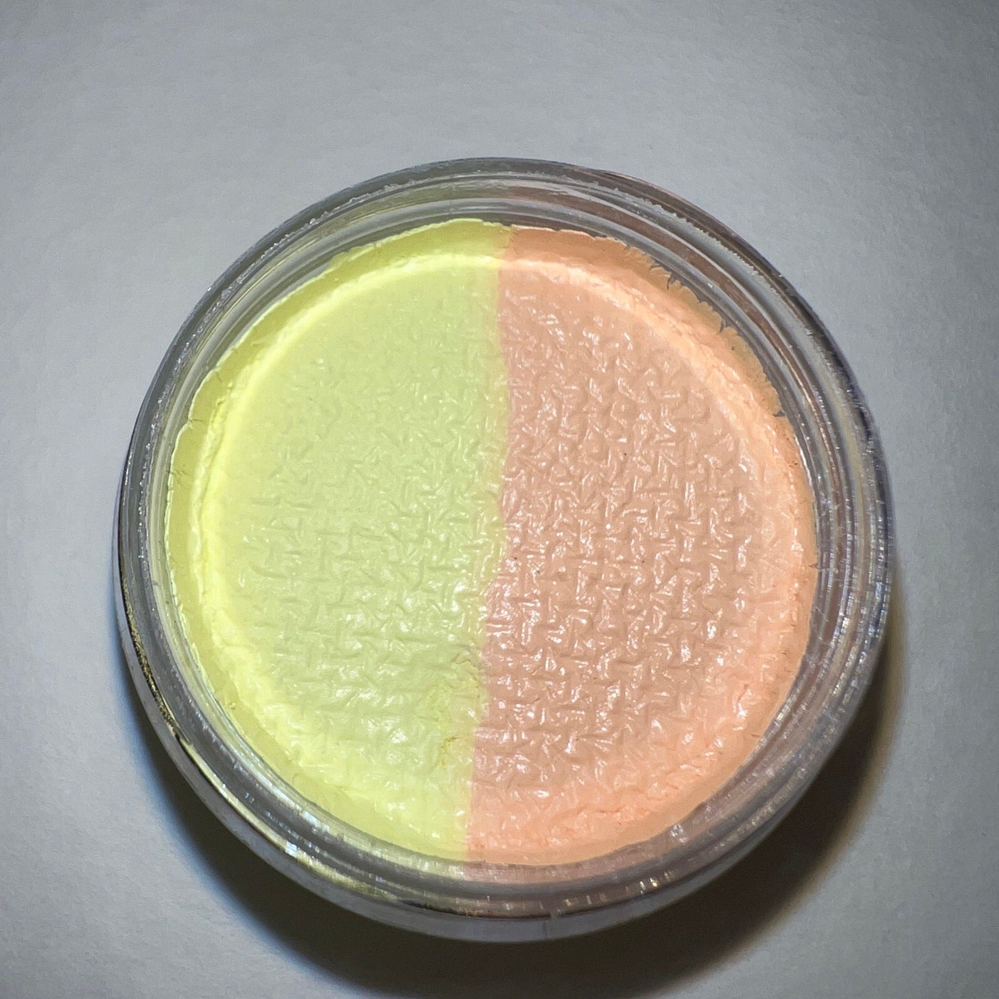 Close-up of honey-toned graphic liner eyeshadow with shimmering gold flecks in sleek black packaging