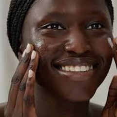 Skincare application, dark skin, smiling face, hands applying product