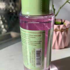 Retinol treatment bottle with pink liquid, green label, and clear plastic, Pixi brand visible