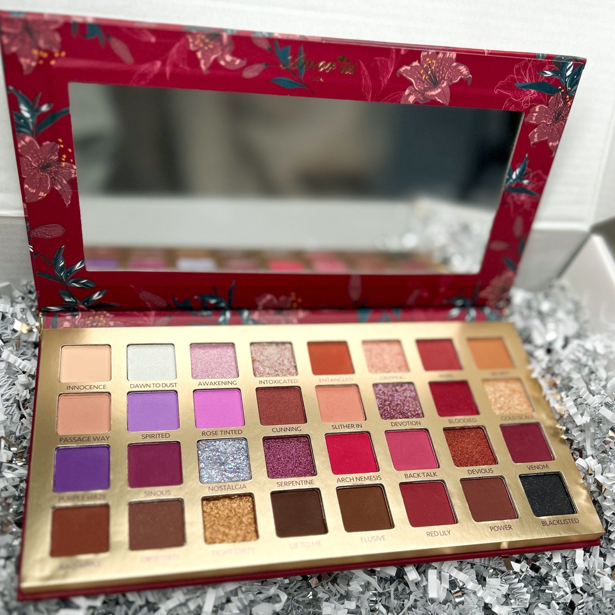 Side view of Pigmented Bad Blood Eyeshadow pot showing deep crimson powder texture and compact case