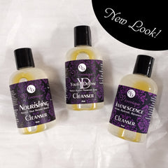 Facial Cleansers, clear bottles with black caps, purple labels with "Véronique" text, on white surface
