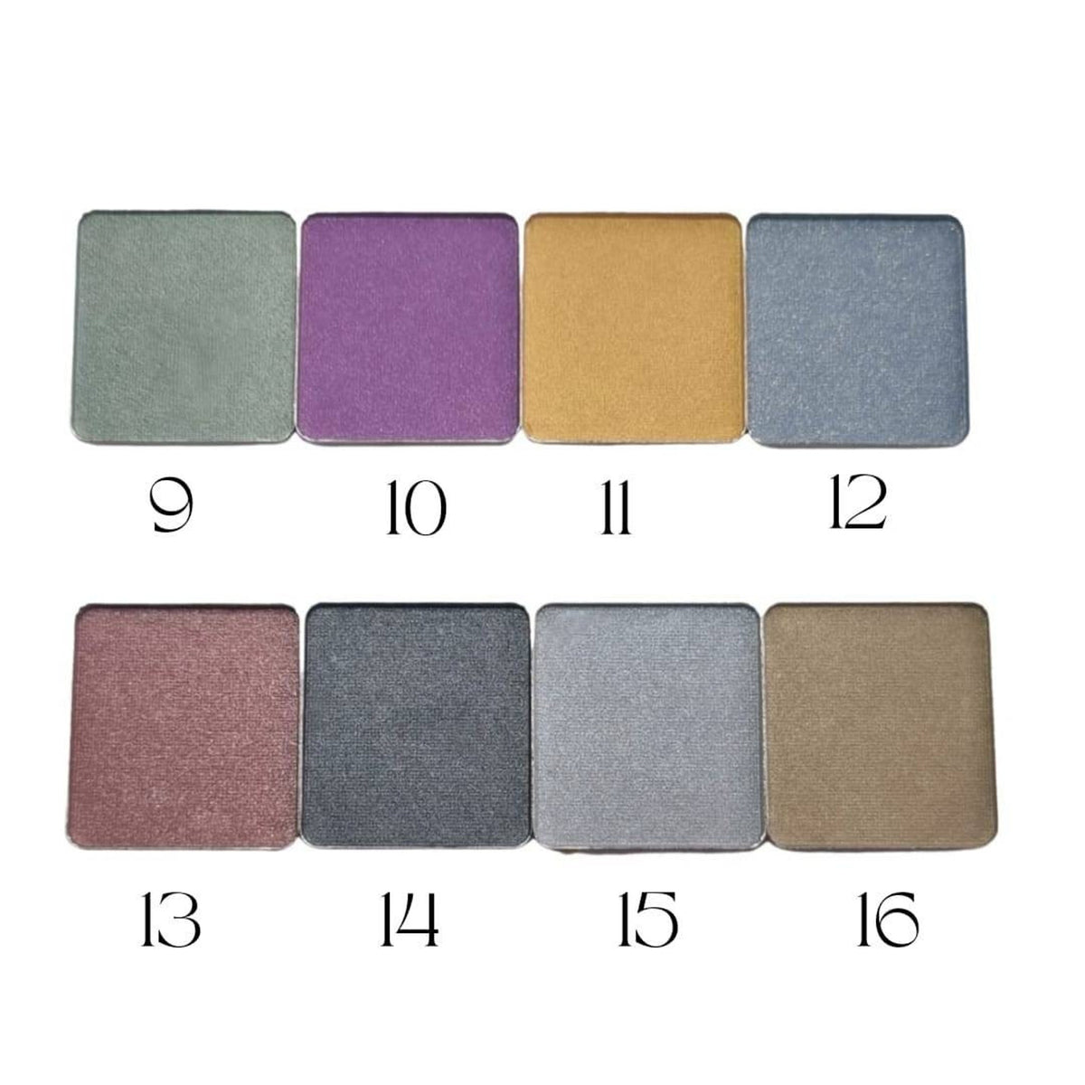 Circular refillable eyeshadow pans in matte earthy tones arranged on a wooden surface